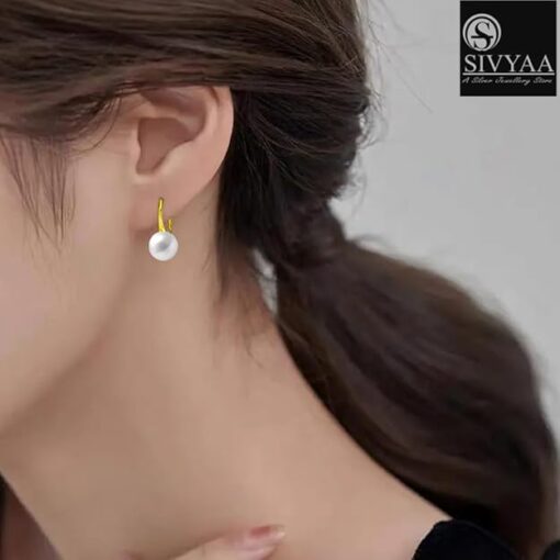 model wearing-SIVYAA gold finish Classic White Pearl Tiny Drop Dangle Earrings